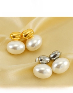 Detail view of large oval pearl earrings in gold and silver titanium steel settings
