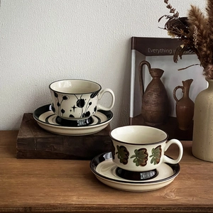 Detail of vintage hand-painted ceramic coffee cups and saucers with floral patterns