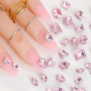 Macro shot of assorted pink faceted rhinestones and crystals for 3D nail art decoration