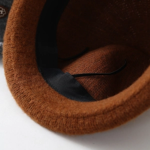Detailed view of knitted bucket hat interior with sweatband and adjustable drawstring