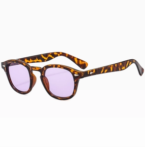 Detail of vintage amber tortoiseshell frame sunglasses with light purple tinted lenses
