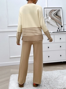 Rear view of women's knitted two-piece set featuring a beige top and camel striped pants