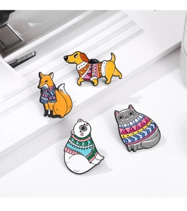 Group shot of four enamel animal brooches in sweaters including fox and polar bear