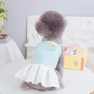 Detail of blue breathable mesh pet dress with happy puppy patch and white pleated skirt