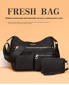 Detail of waterproof black nylon crossbody bag with multi-pocket and gold hardware