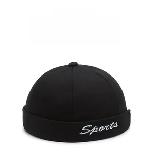 Close-up of Sports letter embroidery on black cotton docker cap with twill texture