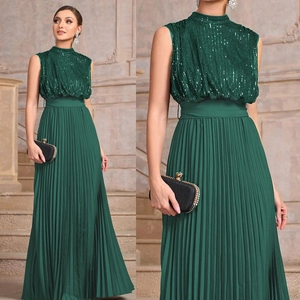 Detail of dark green sleeveless evening gown with sequined bodice and pleated skirt