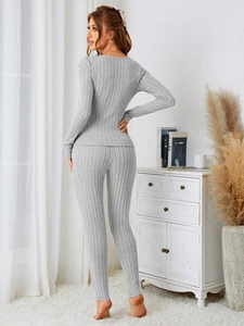 Detail of light grey ribbed knit pajamas set showing fabric texture and V-neck top