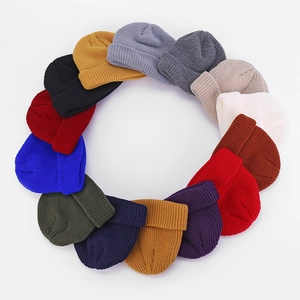 Detailed view of 14 colorful knitted beanies showcasing ribbed texture and elastic design