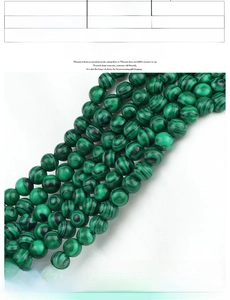 Detail of 8mm green malachite beads with alloy owl charm and star accents