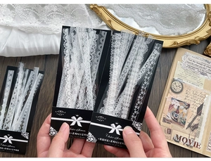 Macro detail of white PET lace stickers with floral hollow patterns for scrapbooking