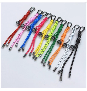 Detail of colorful braided keychains with metal bells and mountaineering buckles
