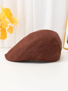 Close-up of brown linen newsboy hat showing breathable coarse weave texture and vintage style