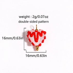Pink heart-shaped glass bead with red ripples and white dots including size dimensions