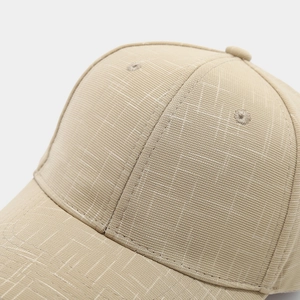 Close-up of beige baseball cap featuring high-quality woven fabric texture and stitching