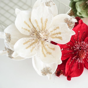 Detailed view of artificial velvet Christmas poinsettia flowers with festive beads