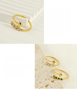 Detailed macro of 18K gold plated stainless steel heart ring with green and white crystals