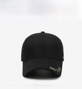 Close-up of Navy Seal gold embroidery on black cotton baseball cap brim and panels