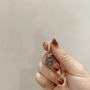 Close-up of a grey bear pendant with gold rhinestone hoop on a freshwater pearl necklace