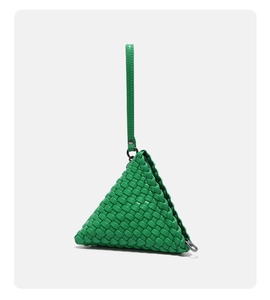 Close-up of vibrant green hand-woven triangular pouch with textured leather-like material