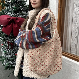 Detailed texture of beige plush lamb fleece tote bag with red heart pattern patterns