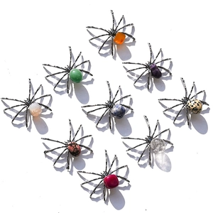 Detailed grid of nine spiders crafted with various natural crystal stones and metal legs