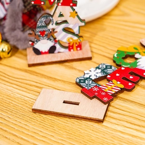 Macro shot of painted Nordic wooden Christmas gnome ornament with festive XMAS letters