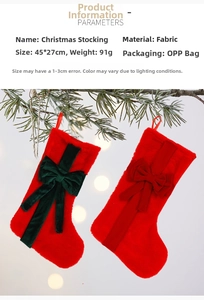 Detail of plush Christmas stocking with bow, 45x27cm size, hanging on pine branch