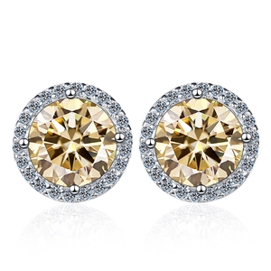 Macro shot of 1 carat round champagne moissanite stud earrings with a silver halo