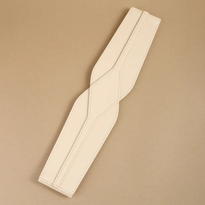 Detailed close-up of cream leather elastic waist belt texture and overlapping craft