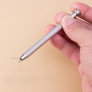 Manual four-prong metal pick-up tool for tiny body jewelry beads with easy grip