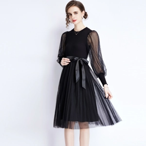 Elegant black knit dress featuring polka dot mesh sleeves and pleated floral tulle skirt