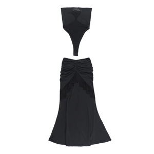 Detail of black halter-neck crop top and pleated mermaid skirt set with ruffles