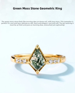 Macro detail of geometric gold ring featuring kite-cut green moss agate and side diamonds