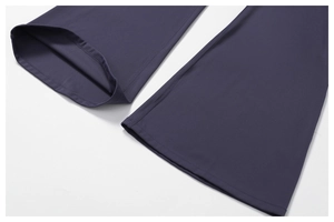 Detail of flared hem with double-needle stitching on navy blue recycled yoga pants