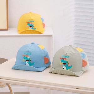 Detailed view of kids dinosaur sun hats in yellow, light blue, and grey with 3D fins