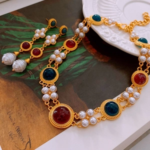 Vintage gold necklace and earrings set with red and green gems and baroque pearls