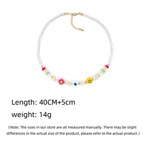 Detail showing 40cm beaded necklace with freshwater pearls, smiley face and evil eye charms