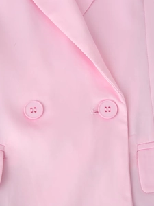 Close-up of pink satin blazer lapel with two matching buttons and premium fabric texture
