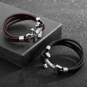 Detail of multi-layer braided leather bracelet with silver anchor clasp in retro style