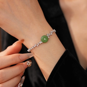 Detail of a green chalcedony bracelet on wrist with zircon stones in silver setting