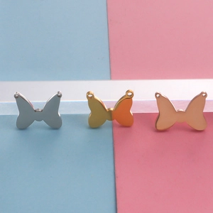 Three butterfly-shaped stainless steel charms in silver, gold, and rose gold finishes