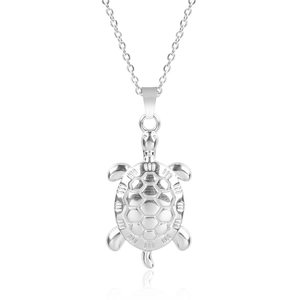 Detailed view of silver stainless steel sea turtle pendant on a delicate link chain necklace