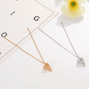 Minimalist gold and silver layered pendant necklaces with sleek conical charm elements
