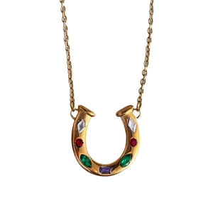 Golden horseshoe U-shaped necklace with colorful zircon gemstones on white background