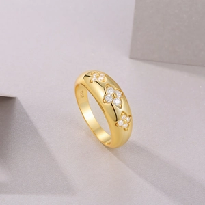 Macro detail of S925 sterling silver stamp and three floral moissanite clusters on gold ring