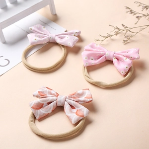 Floral bow baby headbands made of soft nylon featuring daisy and wave patterns