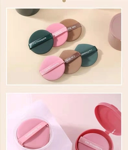 Detail view of round non-latex cushion puffs in pink and green with ribbon handles