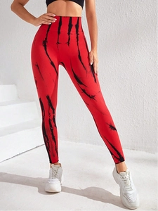 Detailed view of high-waisted seamless tie-dye yoga pants with red and black marble texture