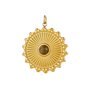 Detailed view of a gold sunburst pendant with a natural stone center and beaded edges